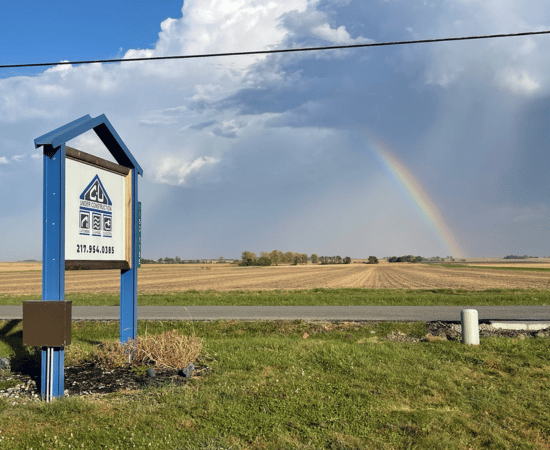 A rainbow over Central Illinois farmland behind the C-U Under Construction Sign