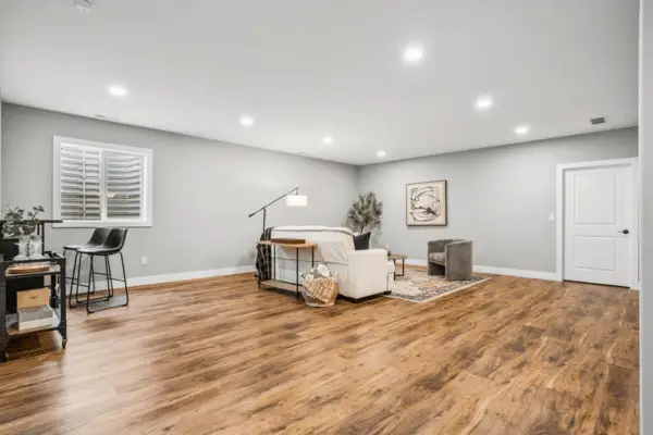 Finished basement with luxury vinyl plank flooring and recessed lighting by C-U Under Construction in Champaign, IL
