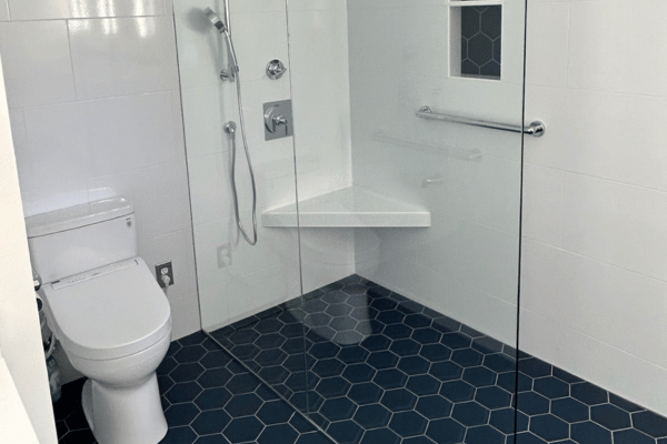 Accessible bathroom remodel with roll-in shower, grab bar, corner bench seat, and hexagon tile floor by C-U Under Construction in Central Illinois
